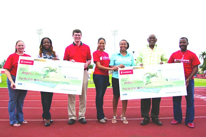 ANGELICA STURRUP (2nd from left) and Arthur Gibson (2nd from right) pose with Scotiabank representatives after winning their visa card promotions for the 2012 Olympic Games. Included in the photo are Kevin Teslyk (third from left), the managing director and Leah Davis (4th from right). Photo by  Dominic Duncombe