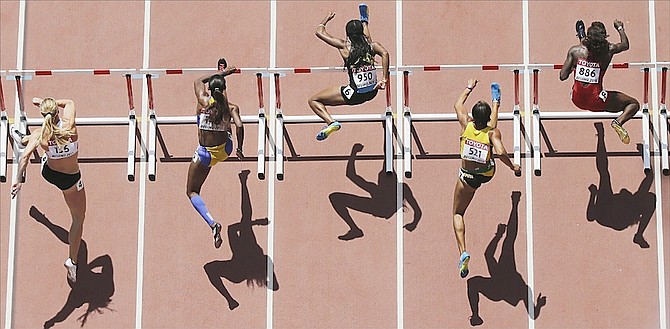 Women’s 100m hurdles runners from left: Austria’s Beate Schrott, Barbados’ Kierre Beckles, Devynne Charlton of the Bahamas, Jamaica’s Kimberly Laing and United States’ Dawn Harper Nelson compete in a round one heat at the World Athletics Championships at the Bird’s Nest stadium in Beijing yesterday.