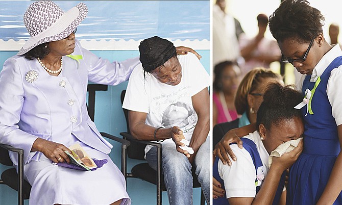 LEFT: The mother of Mizilana Beauchamp is comforted by Cynthia “Mother” Pratt. 
