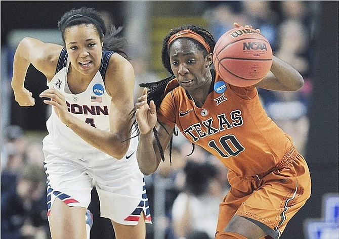 Texas’ Lashann Higgs, right, steals the ball from Connecticut’s Napheesa Collier.