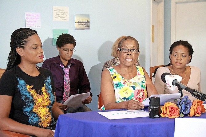 Donna Nicolls speaking at the press conference, flanked by Terneill Burrows and Noelle Nicolls. 

Photo: Tim Clarke/Tribune Staff