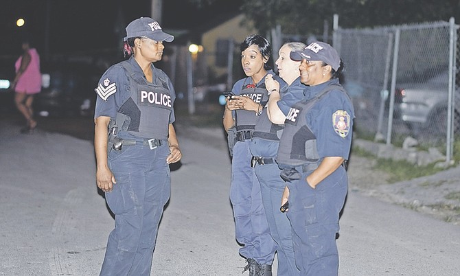 POLICE at the scene of the shootings on Tuesday night. Two men died and a child was injured.