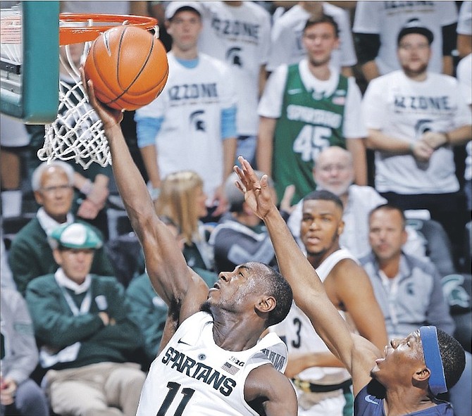 Michigan State’s Tum Tum Nairn (11) puts up a layup against Northwood’s Jarel Woolridge during the first half of an NCAA college basketball exhibition game on Thursday in East Lansing, Michigan. (AP)