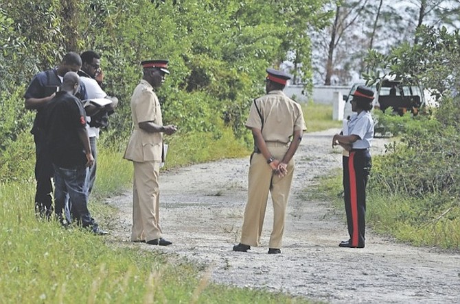 Police at the scene of the shootings in which two people were killed and three were wounded in McLeans Town, Grand Bahama, on Thursday. 
Photo: Vandyke Hepburn/BIS
