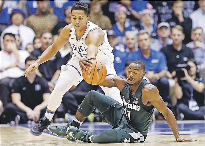 Duke’s Frank Jackson and Michigan State’s Lourawls Nairn Jr (11) reach for the ball during the first half of an NCAA game in Durham, N.C. (AP)