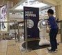 A boy plays with Pepper the robot at …