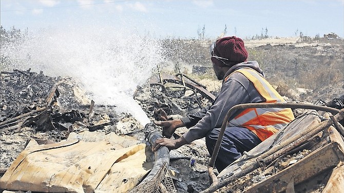 A firefighter tackling the blaze at the dump. Photo: Terrel W. Carey/Tribune Staff