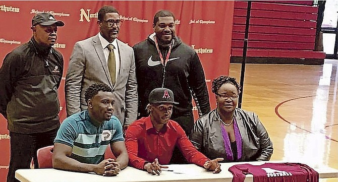 TORRES INGRAHAM (sitting in the centre) yesterday officially signed his letter of intent to join the Alma College Scots.