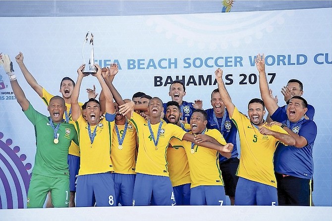 TEAM BRAZIL celebrate yesterday after routing Tahiti 6-0 to win the FIFA Beach Soccer World Cup final at the new Malcolm Park beach soccer stadium.
                                                                                                                                                                                                        Photo: Shawn Hanna/Tribune Staff