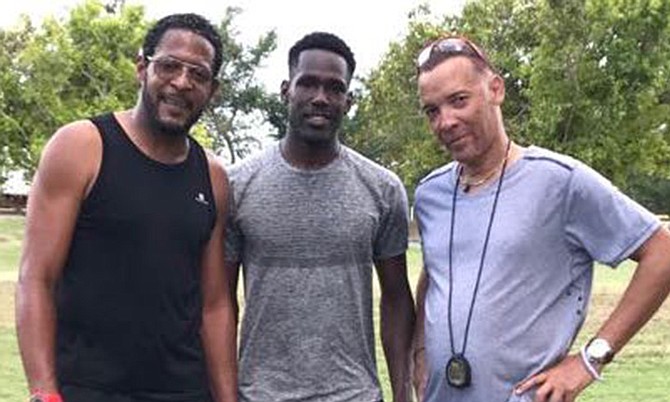 Bahamian Donald Thomas flanked by Cuban world record holder Javier Sotomayor (left) and his coach Luis Pinilo (right) at a training session in Cuba.