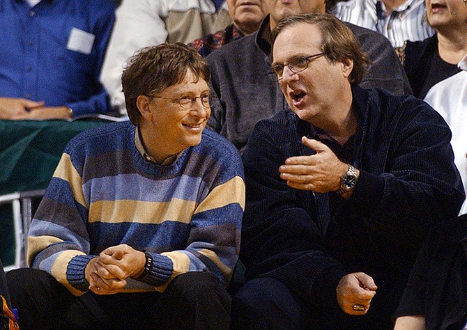 Microsoft Chairman Bill Gates, left, chats with Portland Trail Blazers owner and former business partner Paul Allen during a game between the Trail Blazers and Seattle SuperSonics in Seattle in 2003. (AP)