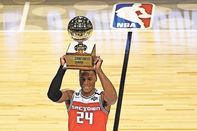 Sacramento Kings’ Buddy Hield holds the trophy after winning the NBA basketball All-Star 3-point contest Saturday in Chicago.

(AP Photo/David Banks)