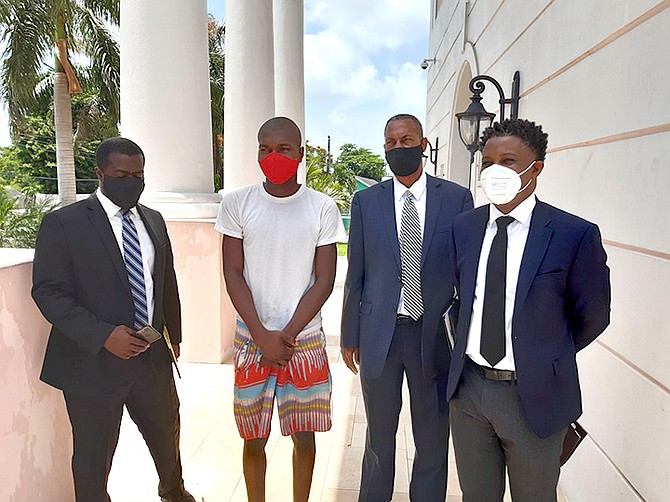 STUDENT DEON DUVERNY, second from left, with attorneys Bjron Ferguson, left, Claude Hanna and Damian White.