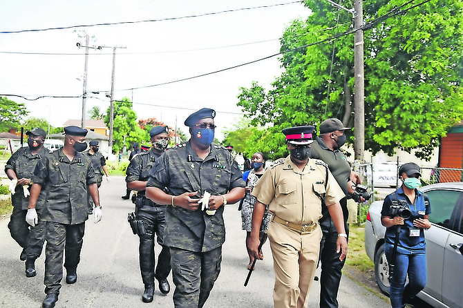 COMMISSIONER of Police Paul Rolle and officers were in the Montel Heights community distributing food coupons, water and masks as a part of the police’s social contribution yesterday. 
Photo: Shawn Hanna/Tribune Staff