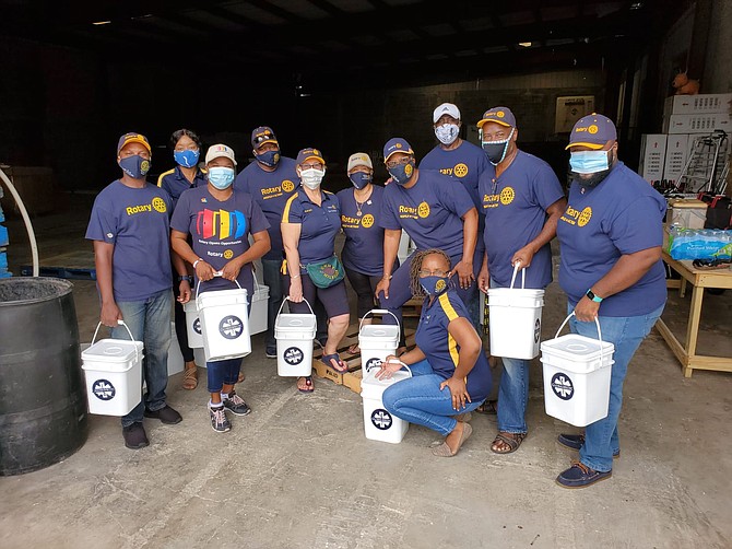 ROTARIANS in action distributing food kits in Grand Bahama.