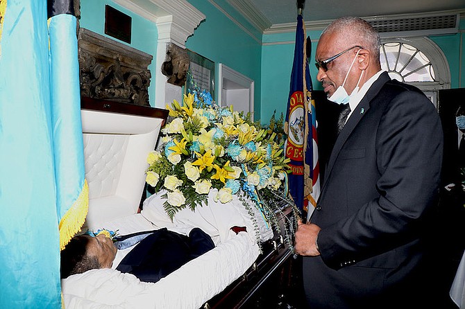 PRIME Minister Dr Hubert Minnis pays respects at the lying in state of James Oswald Ingraham at the House of Assembly yesterday. Photos: Letisha Henderson/BIS