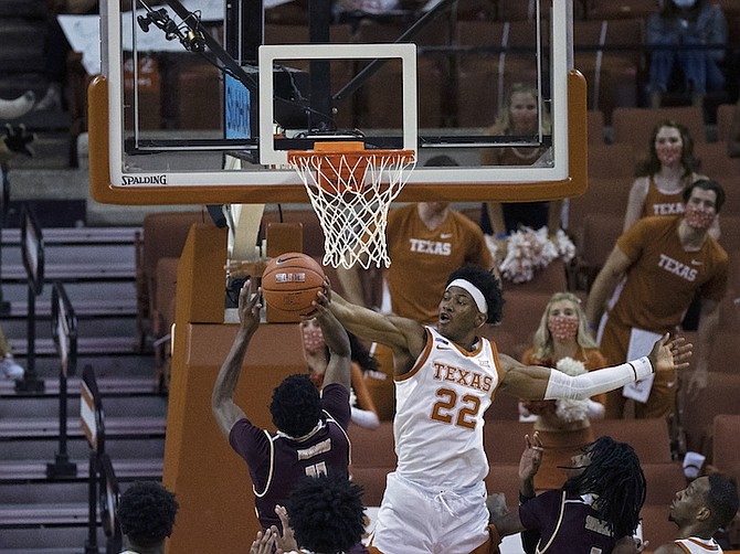 Texas forward Kai Jones (22) blocks a shot by Texas State guard Shelby Adams during the second half of an NCAA college basketball game Wednesday, in Austin, Texas. (AP Photo/Michael Thomas)