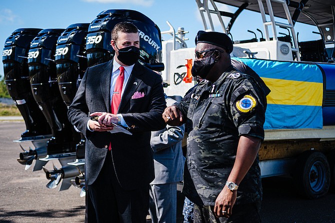 POLICE Commissioner Paul Rolle (right) and US Embassy Director of International Narcotics and Law Enforcement Garrett Wilkerson with the United States’ donation of six Mercury Verado engines.