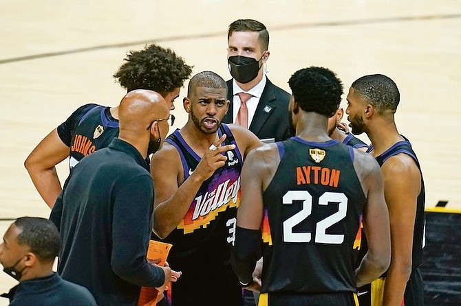 Suns guard Chris Paul, middle, huddles with head coach Monty Williams, bottom left, centre Deandre Ayton (22) and teammates during the second half of Game 5 of the NBA Finals against the Milwaukee Bucks on Saturday in Phoenix.

(AP Photo/Ross D. Franklin)