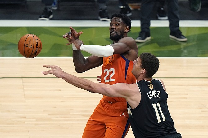 Phoenix Suns centre Deandre Ayton (22) and Milwaukee Bucks centre Brook Lopez (11) battle for the ball during the first half of Game 6 of basketball’s NBA Finals in Milwaukee, Tuesday. (AP Photo/Paul Sancya)