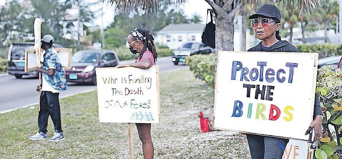 PROTEST signs being held up at Saunders Beach Park at the weekend. A march is planned on Wednesday. Photo: Racardo Thomas/Tribune Staff