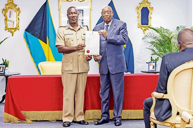 Assistant Commissioner of Police Leamond Deleveaux being sworn in by Governor General CA Smith. 
Photo: Austin Fernander