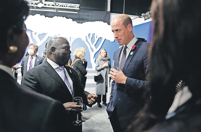 BRITAIN’S PRINCE WILLIAM, right, speaks with Prime Minister Philip “Brave” Davis at the COP26 UN Climate Summit in Glasgow, Scotland, last year.