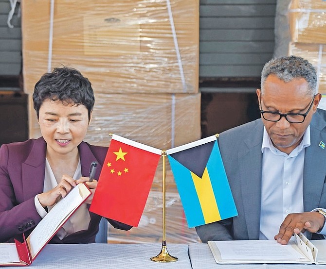 CHINESE ambassador Dai Qingli, left, with Minister of Health and Wellness Dr Michael Darville.