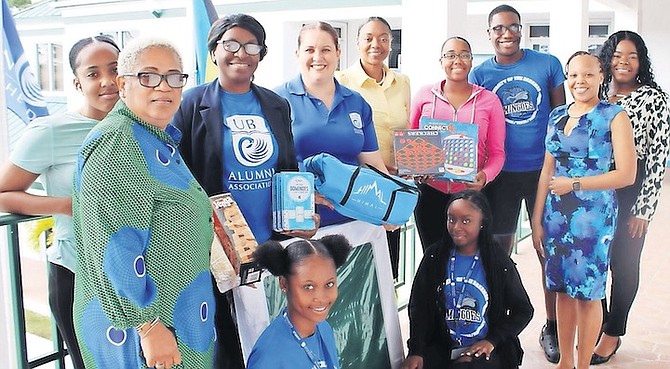 CHAPTER president Aurelia Pinder (fourth from left) and members of the GB Chapter of the UB Alumni Association present board games to Autherine Turnquest-Hanna, assistant director of campus life at UB North (front left) and students of UB North on Monday.