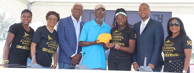 SPECIAL Olympics director Gilbert Williams receives a gift from LOC intern Sherinique Sears. Looking on are Pauline Davis, Janeen McCartney and Mike Sands.
