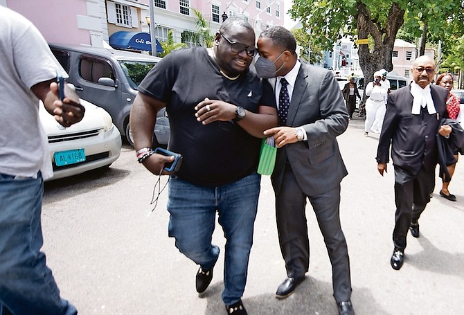 Long Island MP Adrian Gibson (right) seen speaking with the Free National Movement’s vice chairman Richard Johnson (left) outside court yesterday after his motion to have his ex-fiancee testify in person failed. 
Photo: Moise Amisial
