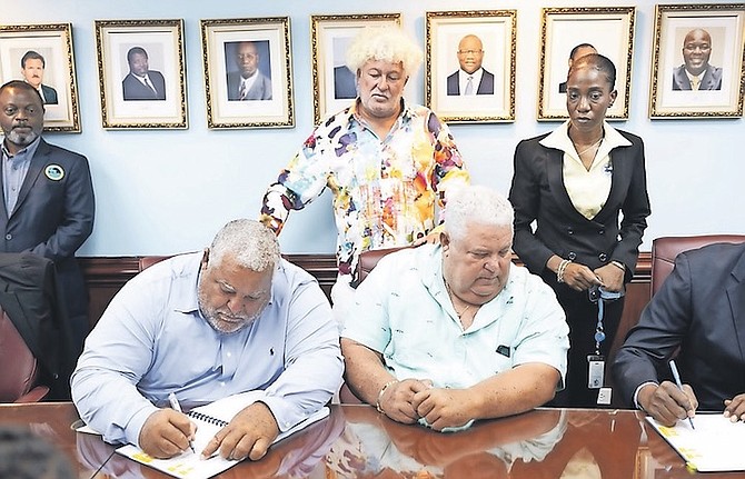 Rowdy Boys Construction signing papers at yesterday’s press conference. Photo: Moise Amisial