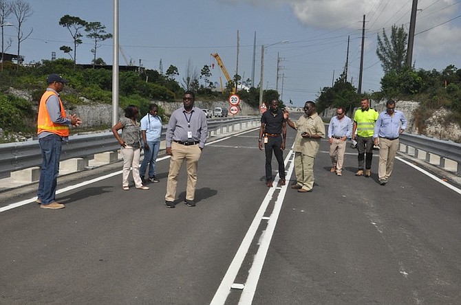 MINISTRY of Works officials including Joy John Mwalgaja (wearing all Khaki); Mr Cox from the Nassau office; Ms Toni Hudson Bannister, the officer in charge of the MOW in Grand Bahama; Troy McIntosh, deputy director and manager of City Maintenance of Building & Development Services at Grand Bahama Port Authority (wearing all black) and Bahamas Hot Mix representatives at the Fishing Hole Road bridge during a joint inspection on Tuesday.
Photo: Vandyke Hepburn