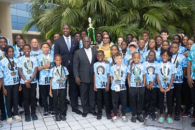 Prime Minister Philip Davis and Zane Lightbourne, MP for Yamacraw, with Team Bahamas swimmers on their return home from the Goodwill Games over the weekend in Kingston, Jamaica.                                                    Photo: Moises Amisial/Tribune Staff