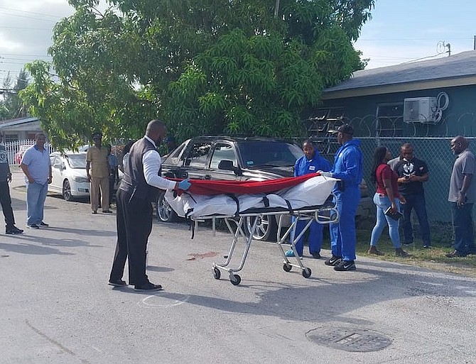 The body of the man is removed from the scene yesterday.
Photo: Racardo Thomas