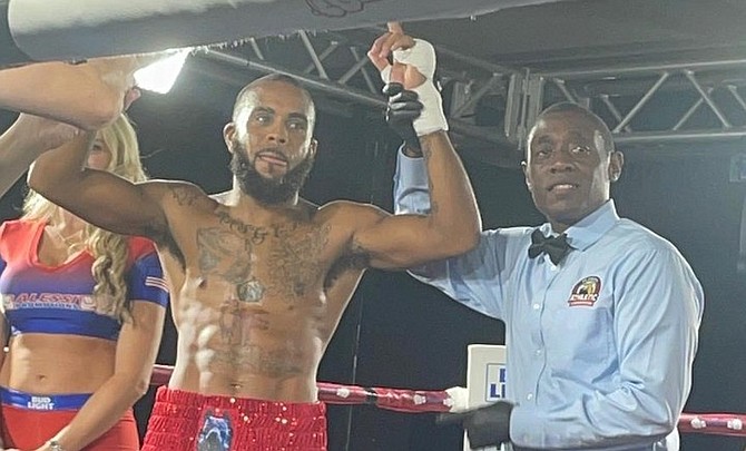 PROFESSIONAL boxer Rashield Williams has his hand raised by the ring referee after the victory.