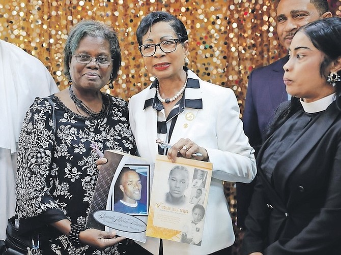 Wife of The Prime Minister Ann Marie Davis and the mother of Rinardo Brown and Carlson Taylor, who were killed on June 15, 2014 and June 16, 2011, pose for a photo during a church service to mark Family’s Of All Murdered Victims’ Day at New Covenant Baptist Church yesterday. 
Photo: Dante Carrer