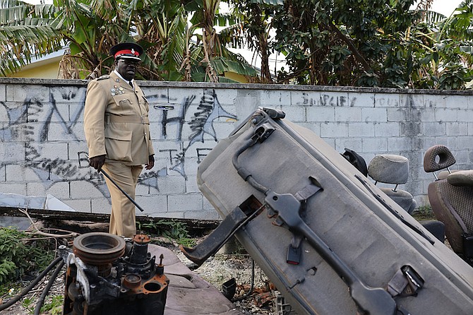 POLICE search derelict vehicles during a press event to promote an Urban Renewal initiative to remove derelict vehicles in Englerston yesterday.
Photos: Dante Carrer