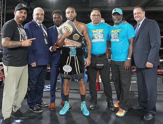 RASHIELD Williams is surrounded by officials and his team after his victory.