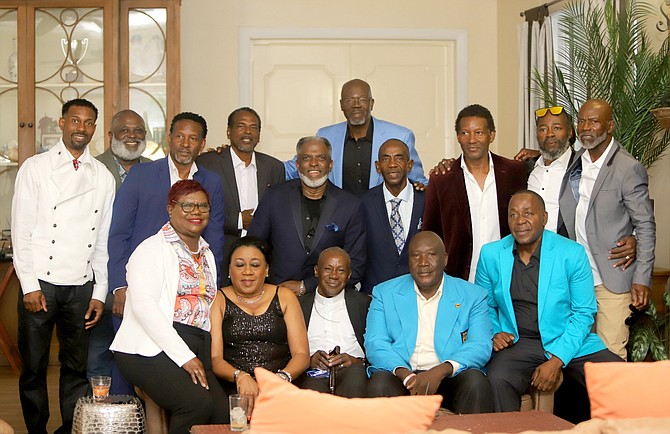 Onesimus 'Pops' Strachan shares a moment with a group of former athletes.