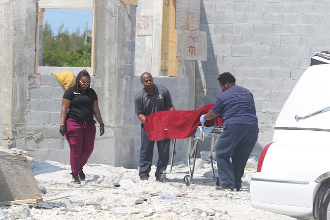 Officials remove the body of a man found at an unfinished house at Bronze Drive in Grand Bahama on May 15, 2024. Photo: Vandyke Hepburn