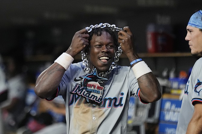 Miami Marlins center fielder Jazz Chisholm Jr. holds the home run chain presented to Otto Lopez after the two-run home run by Lopez during the eighth inning of a baseball game against the Detroit Tigers, Monday, May 13, 2024, in Detroit. (AP Photo/Carlos Osorio)