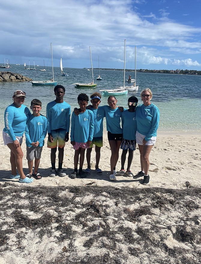 Long Island’s Mack Knowles Junior Sailing Club members pose behind stunning blue waters at the Sir Durward Knowles National Junior Sailing Championships. Pictured smiling, left to right, co-coach Dian Knowles, Giovanni, Suo, Eulano Rolle, Kristos Knowles, Drake Knowles, Dakota Knowles, Edward Knowles and President Sandra Cooke.