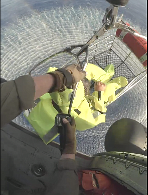 A man adrift on a disabled boat is lifted aboard a US Coast Guard helicopter yesterday. Photo: USCG