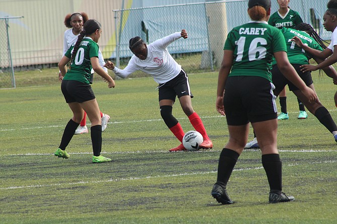 PLAY ACTION: Teams from both the BAISS and GSSSA kicked it into high gear on day one of the Samuel P Haven Jr Soccer Nationals at the Roscow A L Davies Soccer Field.