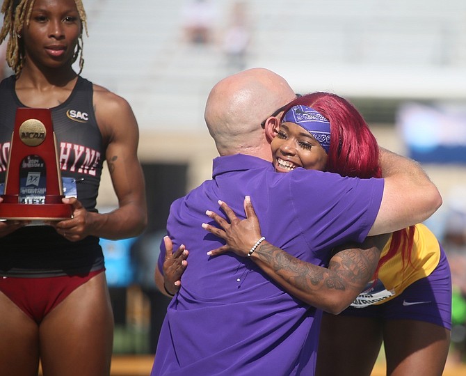 Denisha Cartwright is congratulated by coach Chris Parno as Alexis Brown of Lenoir-Rhyne looks on. Photo: Gene Cassell/Washburn