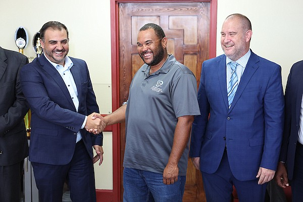 Minister of Works and Family Island Affairs Clay Sweeting (left) shakes hands with SJK Construction and Engineering Services President Stepfan Knowles as Antiquities Monuments & Museums Corporation (AMMC) Director Dr Christopher Curry (right) looks on during a contract signing for repairs and renovations to the Fort Fincastle Water Tower on May 28, 2024. 
Photos: Dante Carrer/Tribune Staff