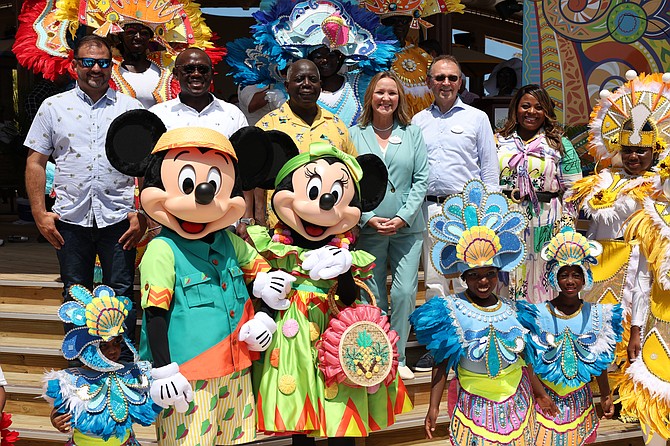 Minister of Works and Family Island Affairs Clay Sweeting, Deputy Prime Minister and Minister of Tourism, Investment and Aviation Chester Cooper, Prime Minister Philip "Brave" Davis, Disney SVP of Sales Sharon Siskie, Disney Signature Experiences President Thomas Mazloum and Disney Signature Experiences VP of Communications and Public Affairs Yolanda Cade pose for a photo with Mickey Mouse, Minnie Mouse and Junkanoo performers during the Community Celebration for Disney Lookout Cay at Lighthouse Point in Eleuthera on May 30, 2024.  Photo: Dante Carrer/Tribune Staff