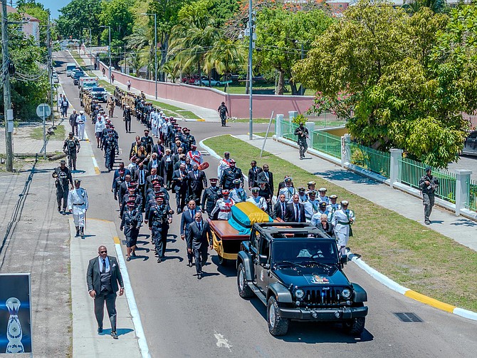 The casket with Loftus Roker makes its way to the burial site accompanied by the RBDF and RBPF on Friday. Photo: Anthon Thompson/BIS