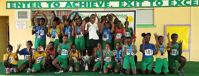 Cleveland Eneas track team celebrate another championship victory last week at the New Providence Public Primary Schools Sports Association’s Track & Field Championships at the Thomas A Robinson Track and Field Stadium.